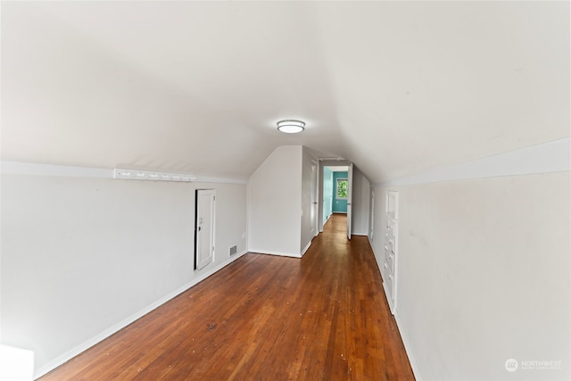 additional living space with lofted ceiling and dark hardwood / wood-style floors