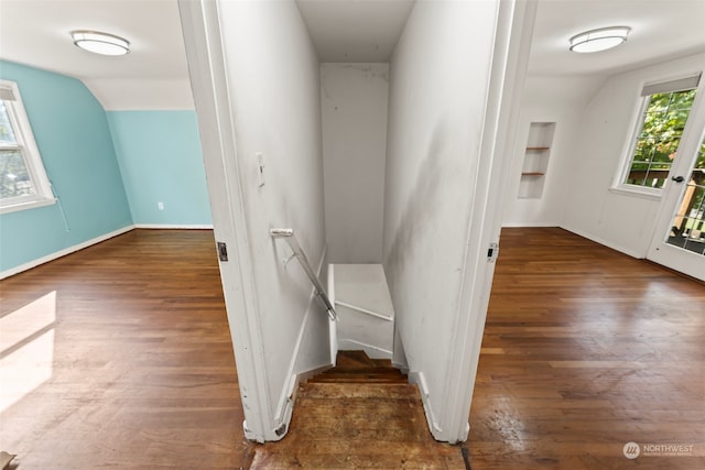 stairway featuring hardwood / wood-style floors and vaulted ceiling