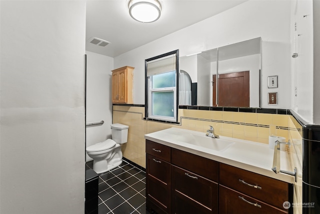 bathroom featuring tile walls, tile patterned flooring, vanity, and toilet