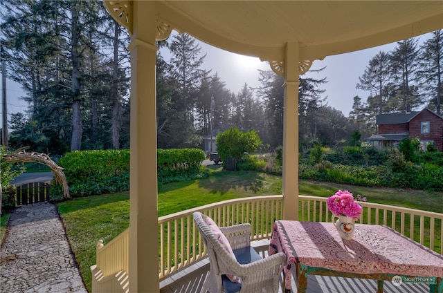 wooden terrace featuring a yard