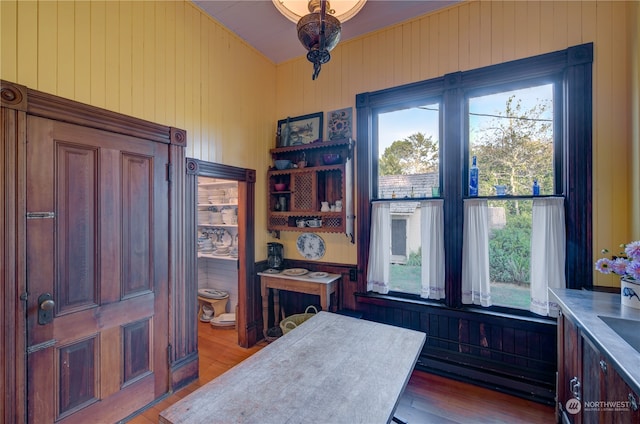 kitchen featuring light hardwood / wood-style floors and wooden walls