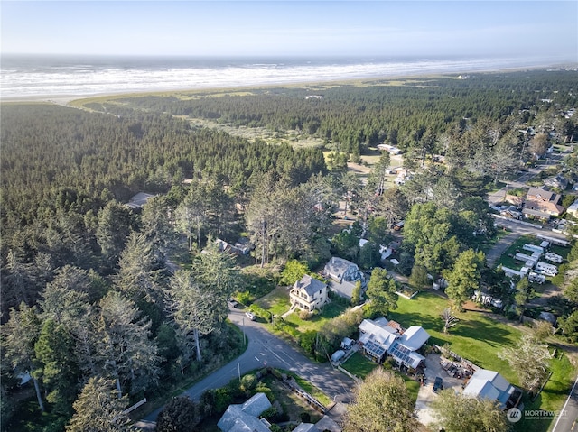 birds eye view of property with a view of the beach and a water view