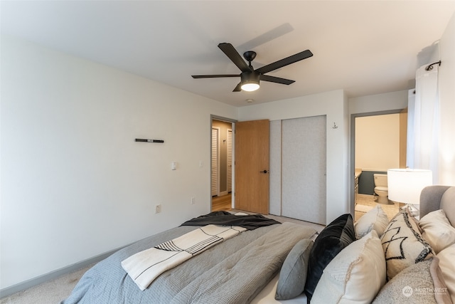 carpeted bedroom with ceiling fan and a closet