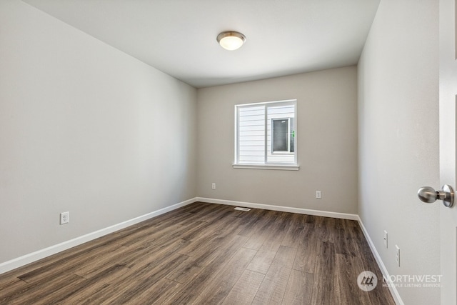 empty room featuring dark wood-type flooring