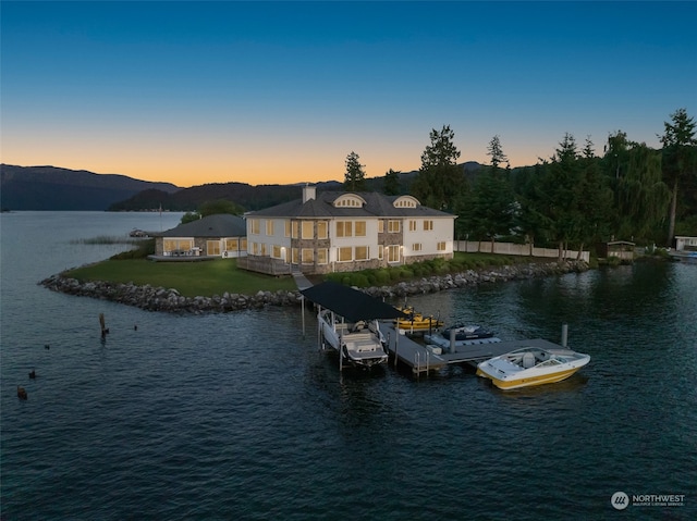 property view of water with a mountain view and a dock