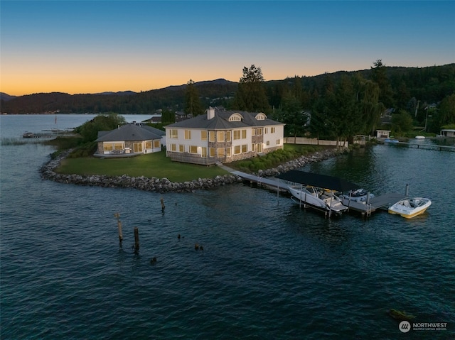 aerial view at dusk with a water and mountain view