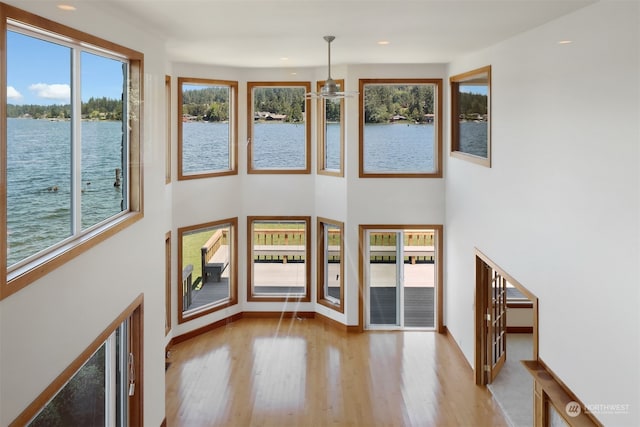 entrance foyer featuring a water view and light hardwood / wood-style flooring