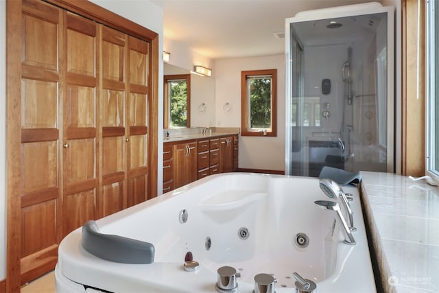 bathroom featuring separate shower and tub and vanity