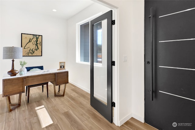 office space with light wood-type flooring