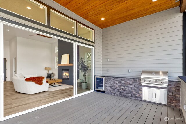 wooden deck featuring beverage cooler, area for grilling, and grilling area