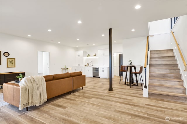 living room featuring beverage cooler and light hardwood / wood-style floors