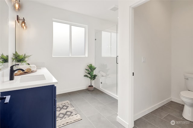 bathroom featuring tile patterned floors, walk in shower, vanity, and toilet