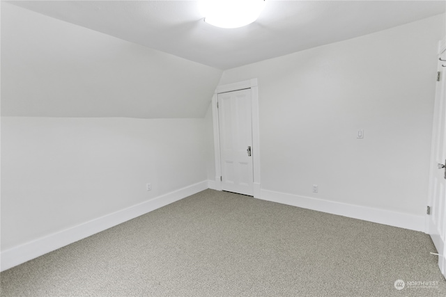 bonus room with carpet floors and vaulted ceiling