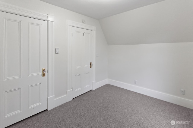 bonus room featuring lofted ceiling and carpet flooring