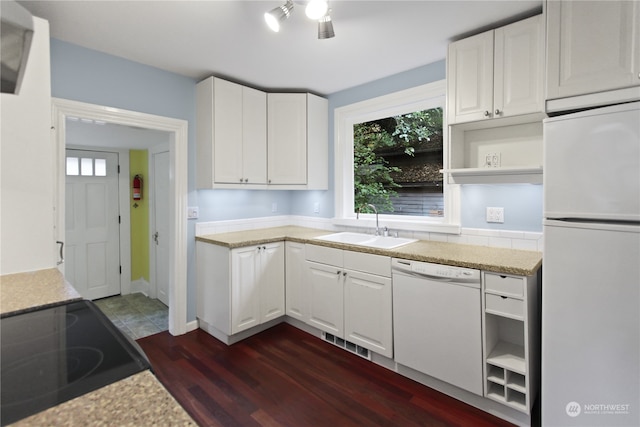 kitchen with sink, white appliances, white cabinetry, and dark hardwood / wood-style floors