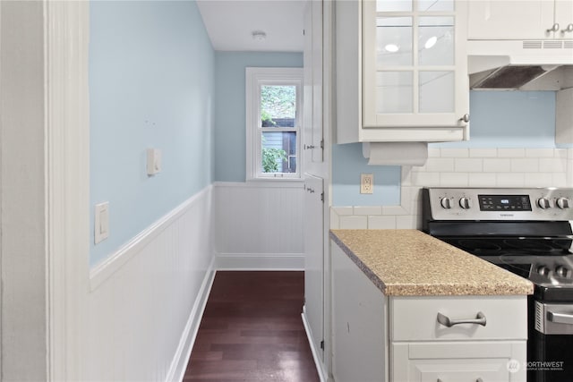 kitchen with stainless steel electric range oven, dark hardwood / wood-style floors, range hood, and white cabinets