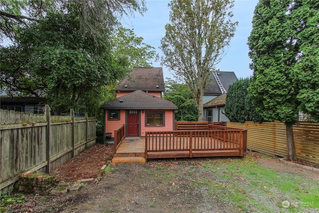 rear view of house featuring a deck