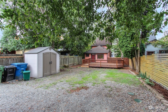 view of yard featuring a shed and a wooden deck