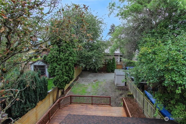 wooden terrace with a shed