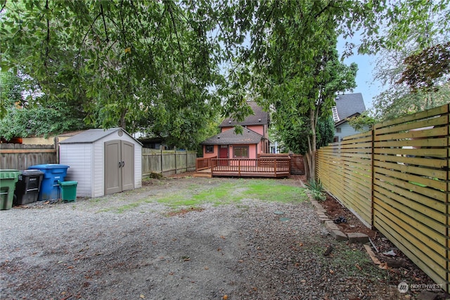 view of yard featuring a storage shed and a deck