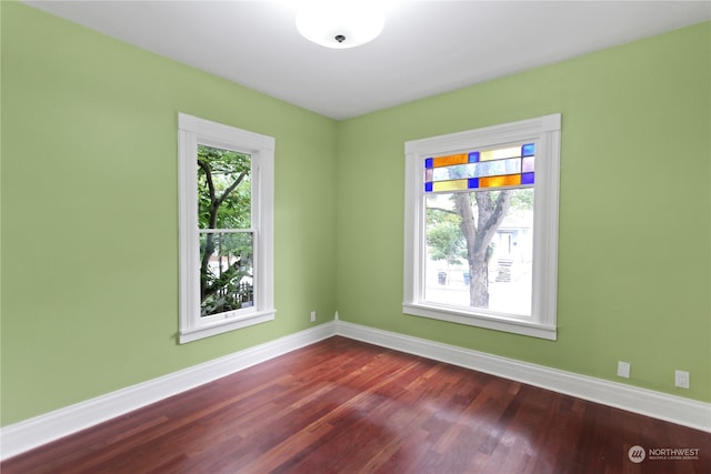 empty room with dark hardwood / wood-style floors