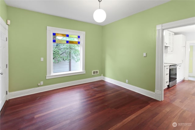 spare room featuring dark hardwood / wood-style flooring