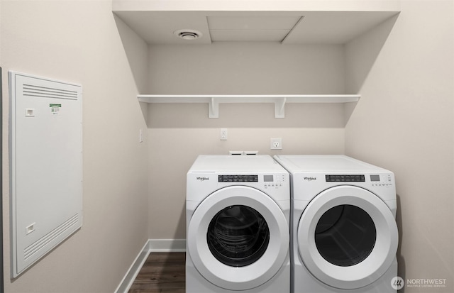 clothes washing area featuring visible vents, baseboards, laundry area, dark wood-style flooring, and washing machine and dryer