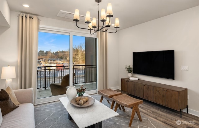 living room featuring a notable chandelier and dark hardwood / wood-style flooring