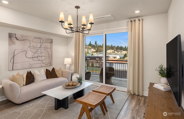 living room featuring a chandelier and hardwood / wood-style floors