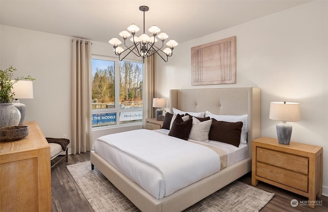 bedroom with dark hardwood / wood-style floors and a chandelier