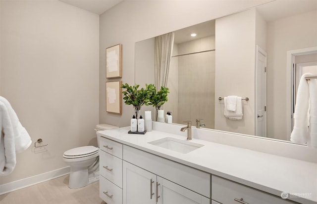 bathroom with vanity, wood-type flooring, and toilet