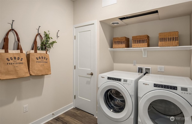 clothes washing area with dark wood-type flooring and washer and clothes dryer