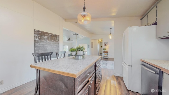kitchen with ceiling fan, stainless steel dishwasher, light countertops, and light wood-type flooring
