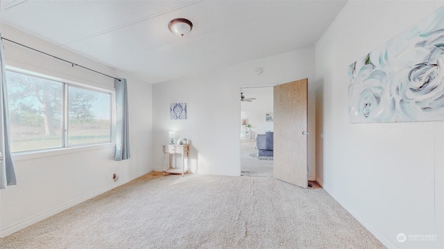 empty room with baseboards and carpet