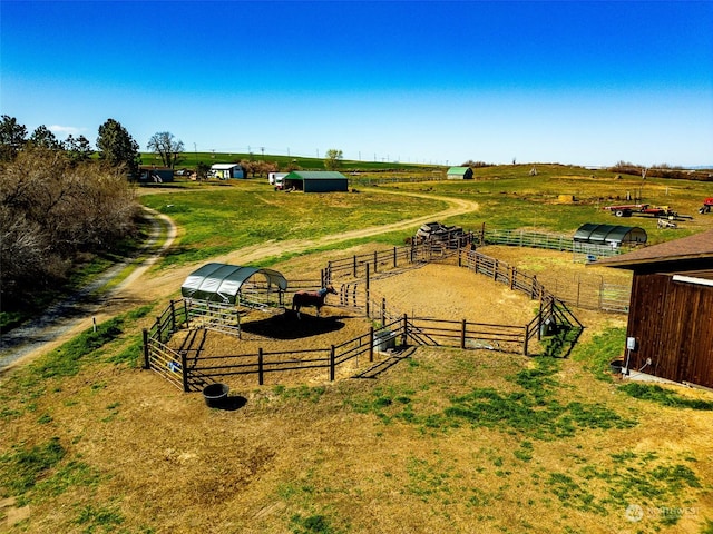 exterior space featuring an exterior structure, an outbuilding, and a rural view