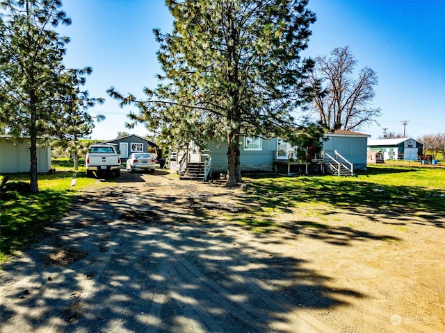 exterior space with driveway and a front yard