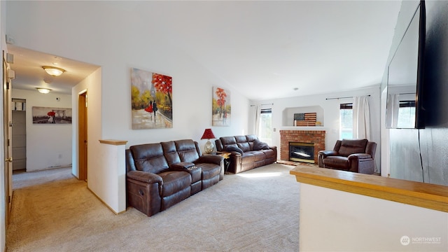 carpeted living room with lofted ceiling and a fireplace