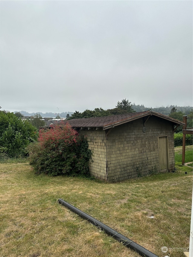 view of outdoor structure featuring a lawn