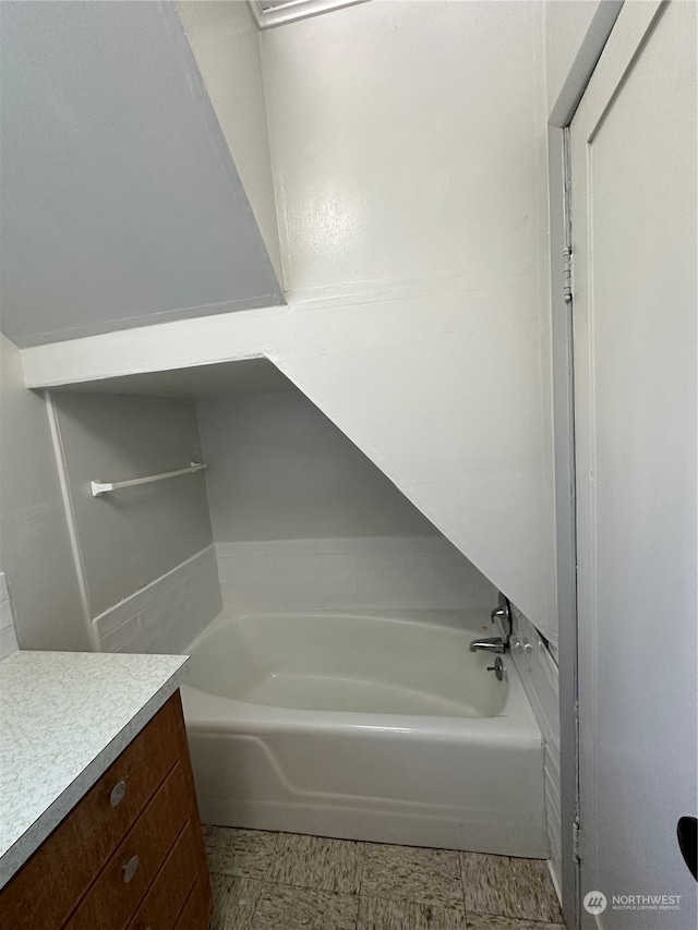 bathroom featuring vanity and a tub to relax in