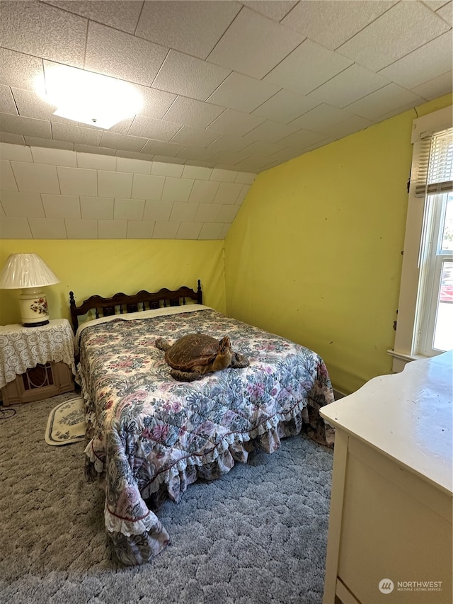 carpeted bedroom featuring vaulted ceiling