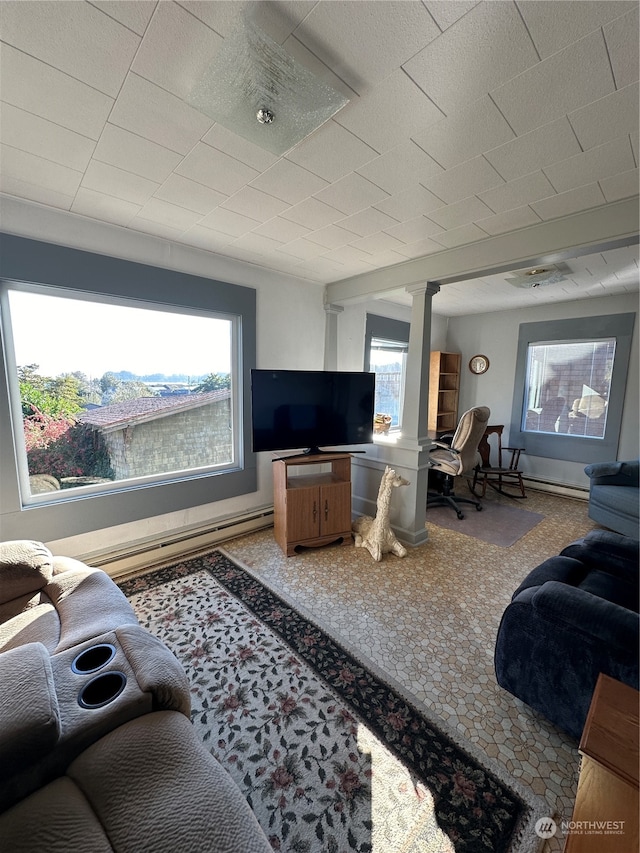 carpeted living room featuring decorative columns