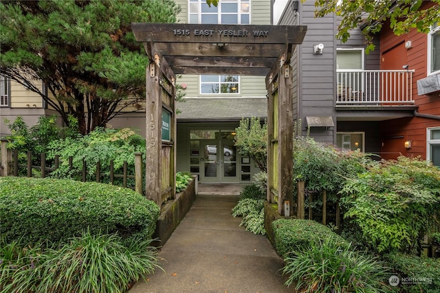 entrance to property with french doors and a balcony