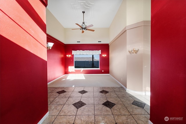 corridor with a towering ceiling and light tile patterned floors