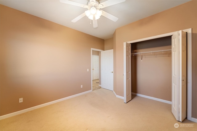 unfurnished bedroom with ceiling fan, a closet, and light carpet