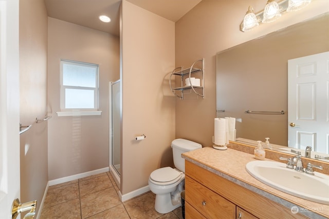 bathroom featuring walk in shower, vanity, tile patterned flooring, and toilet