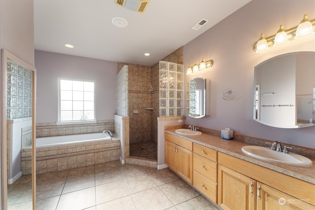 bathroom featuring vanity, plus walk in shower, and tile patterned flooring