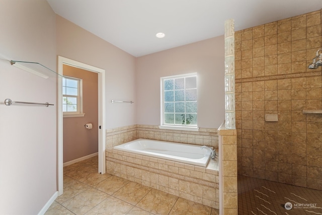 bathroom with tile patterned flooring and separate shower and tub