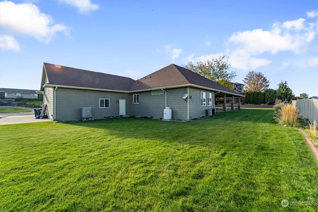 back of property featuring a lawn