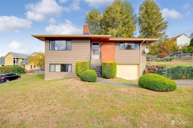 view of front of house featuring a front yard and a garage