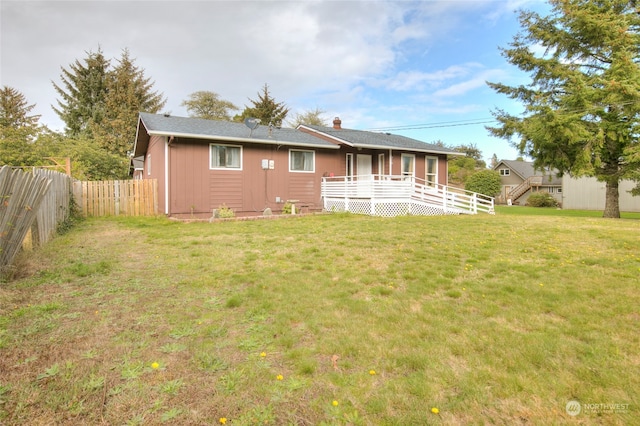 back of house with a lawn